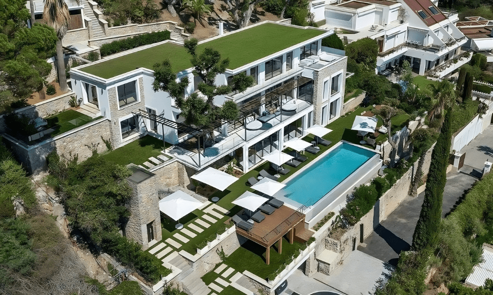 Villa Hotel Bassa Californie in Cannes, French Riviera, France – nighttime aerial view of the illuminated villa and coastline